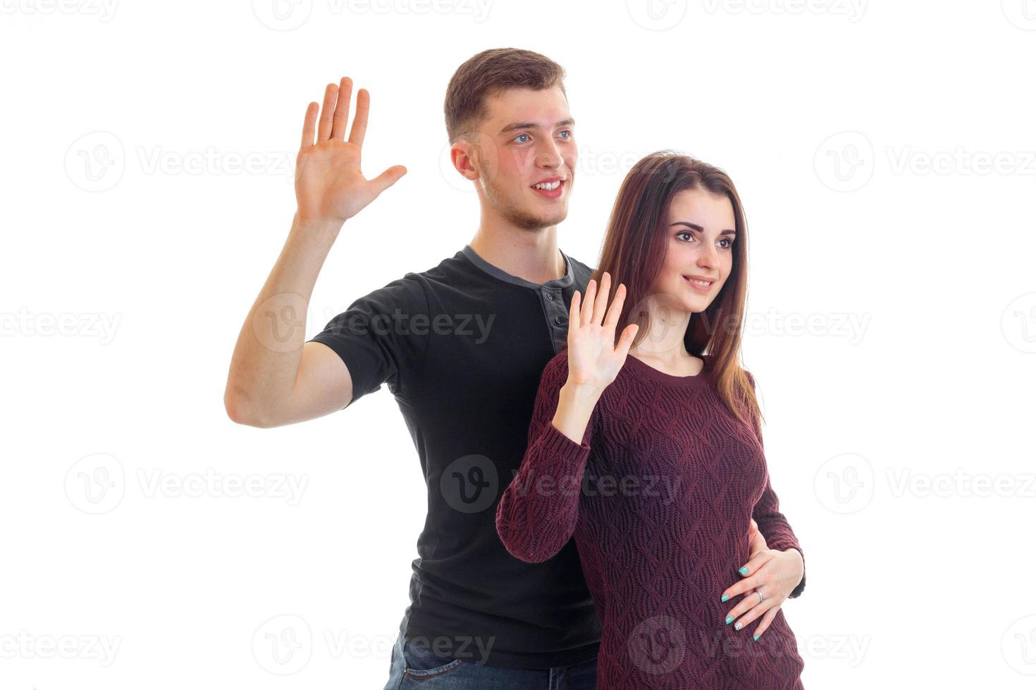 young smiling boy and girl raised palms up and look forward photo