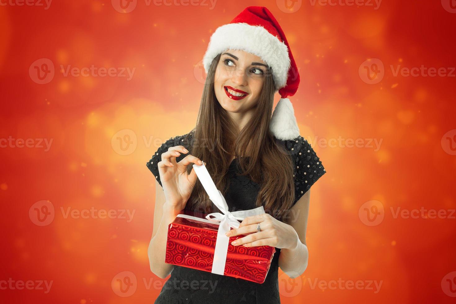 cutie brunette woman in santa hat photo