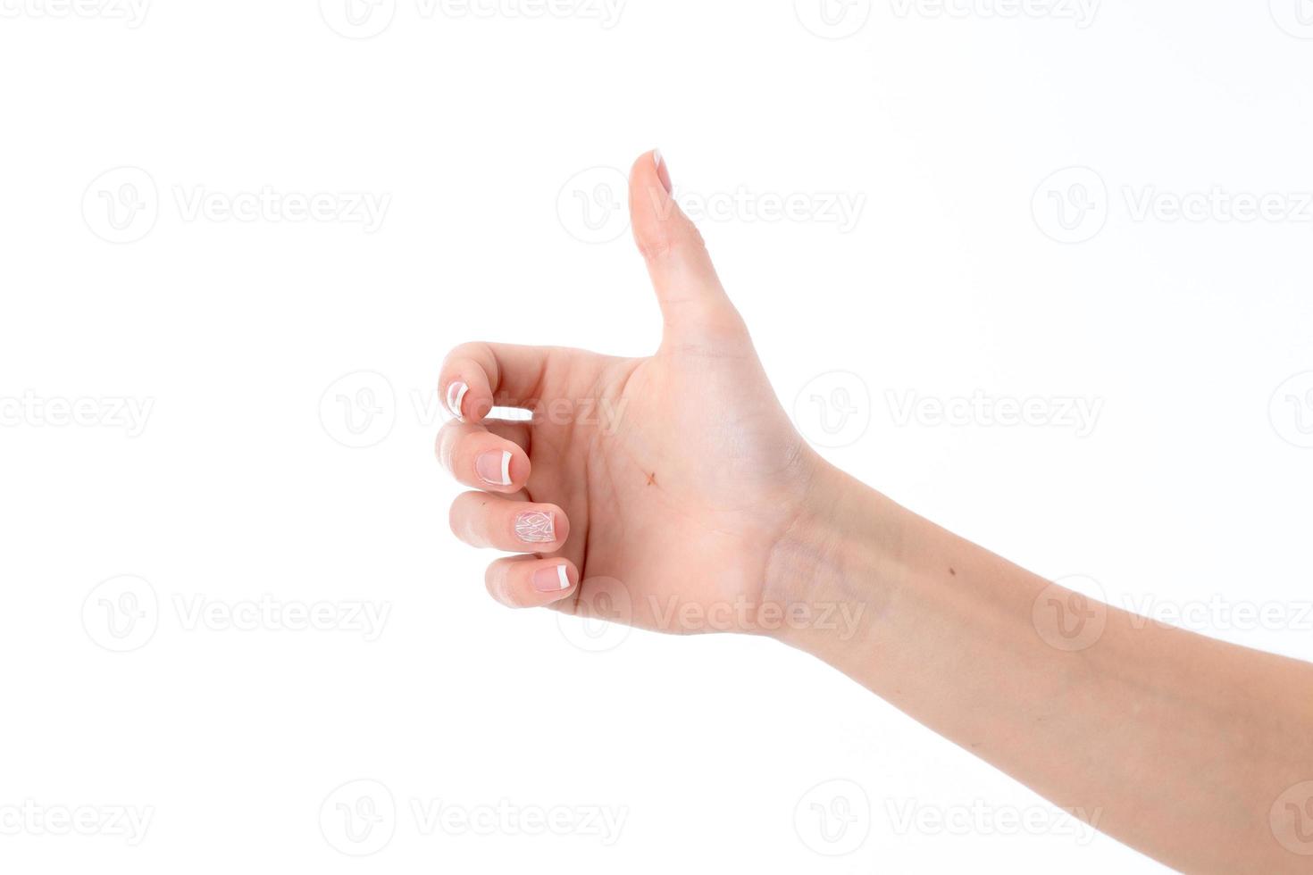 female hand showing the gesture with a raised thumb up isolated on white background photo