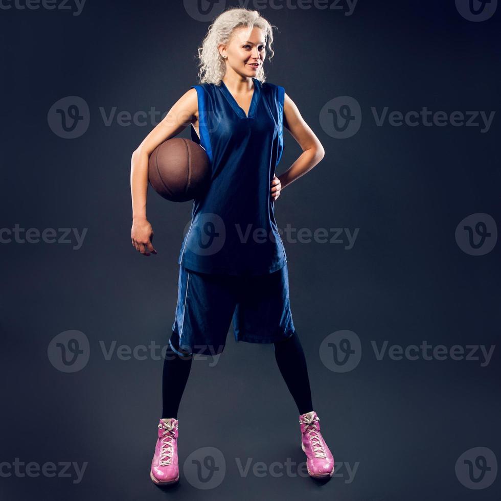 Woman basketballer in blue jersey photo