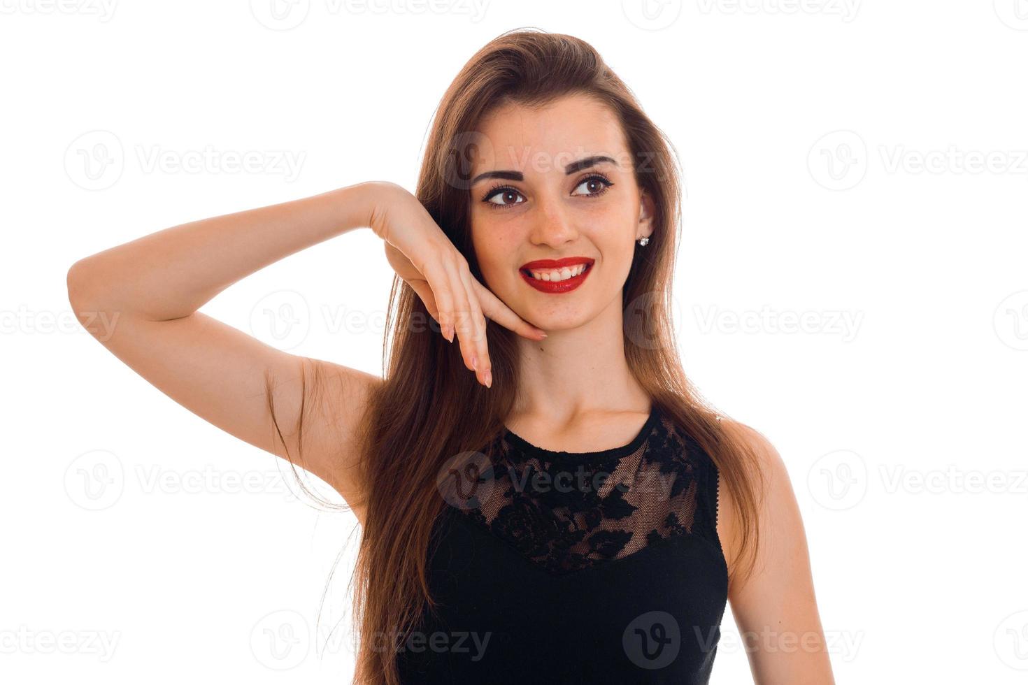 happy young brunette lady with red lips and black dress looking away and smiling isolated on white background photo