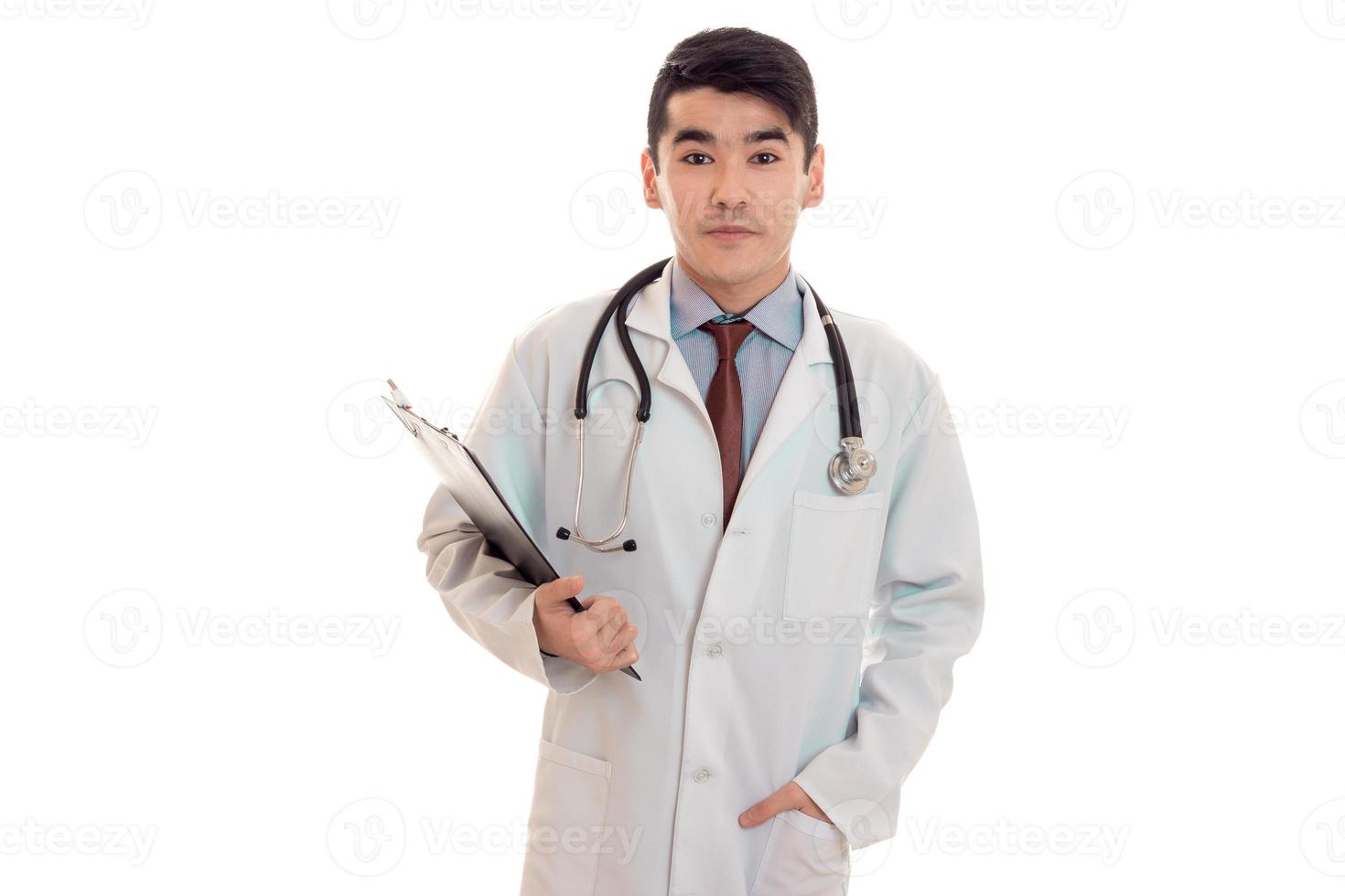 a young doctor in a white lab coat with a stethoscope holding a Tablet for securities photo