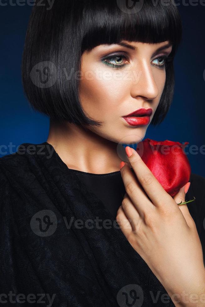 Sensual female looking away in studio on blue backgorund photo