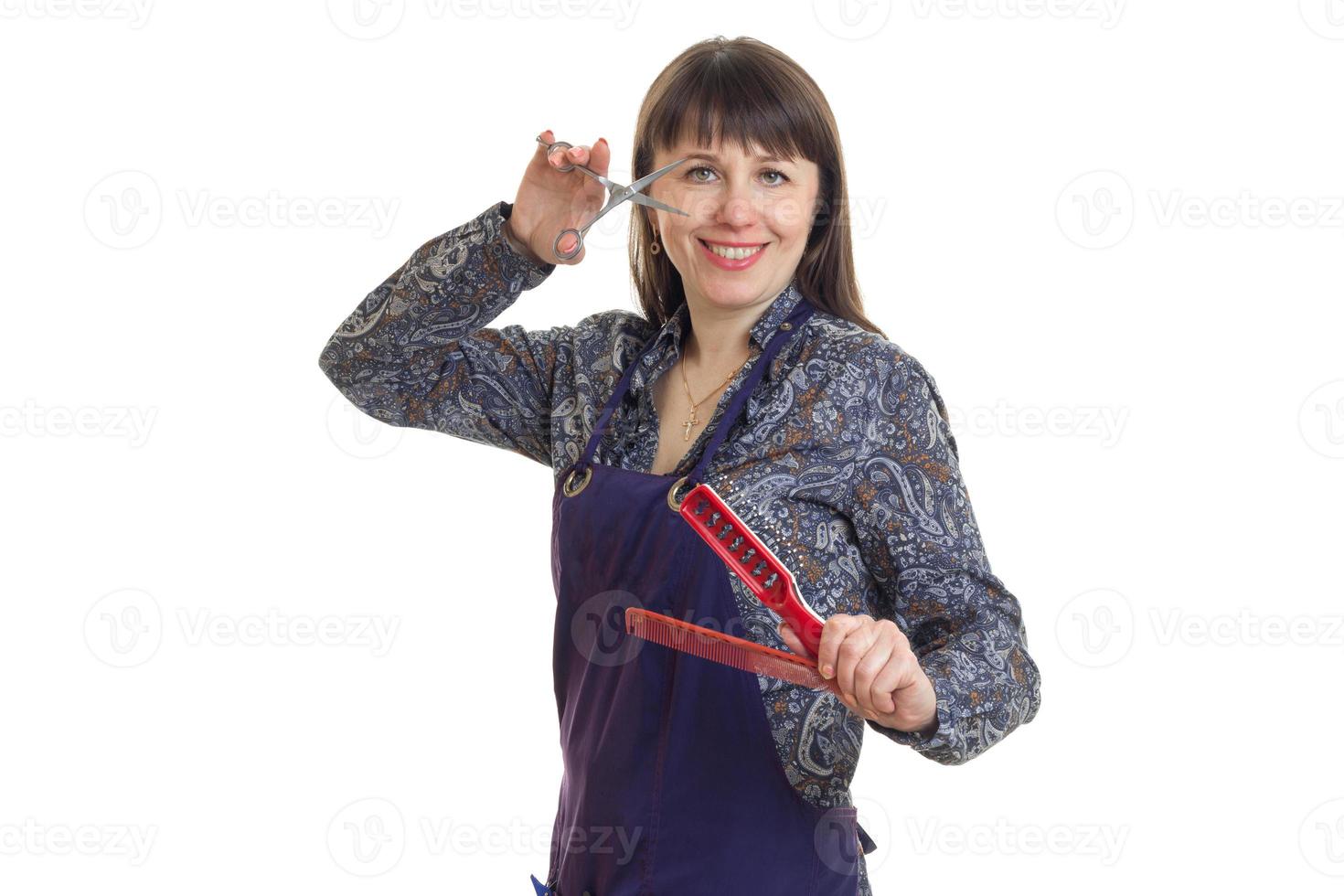 beautiful woman stylist with tools in the hands smiling at camera photo