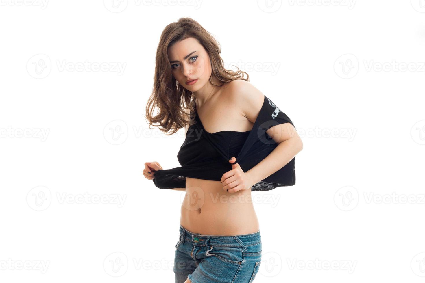 pretty young brunette girl in short shirt looking at the camera photo