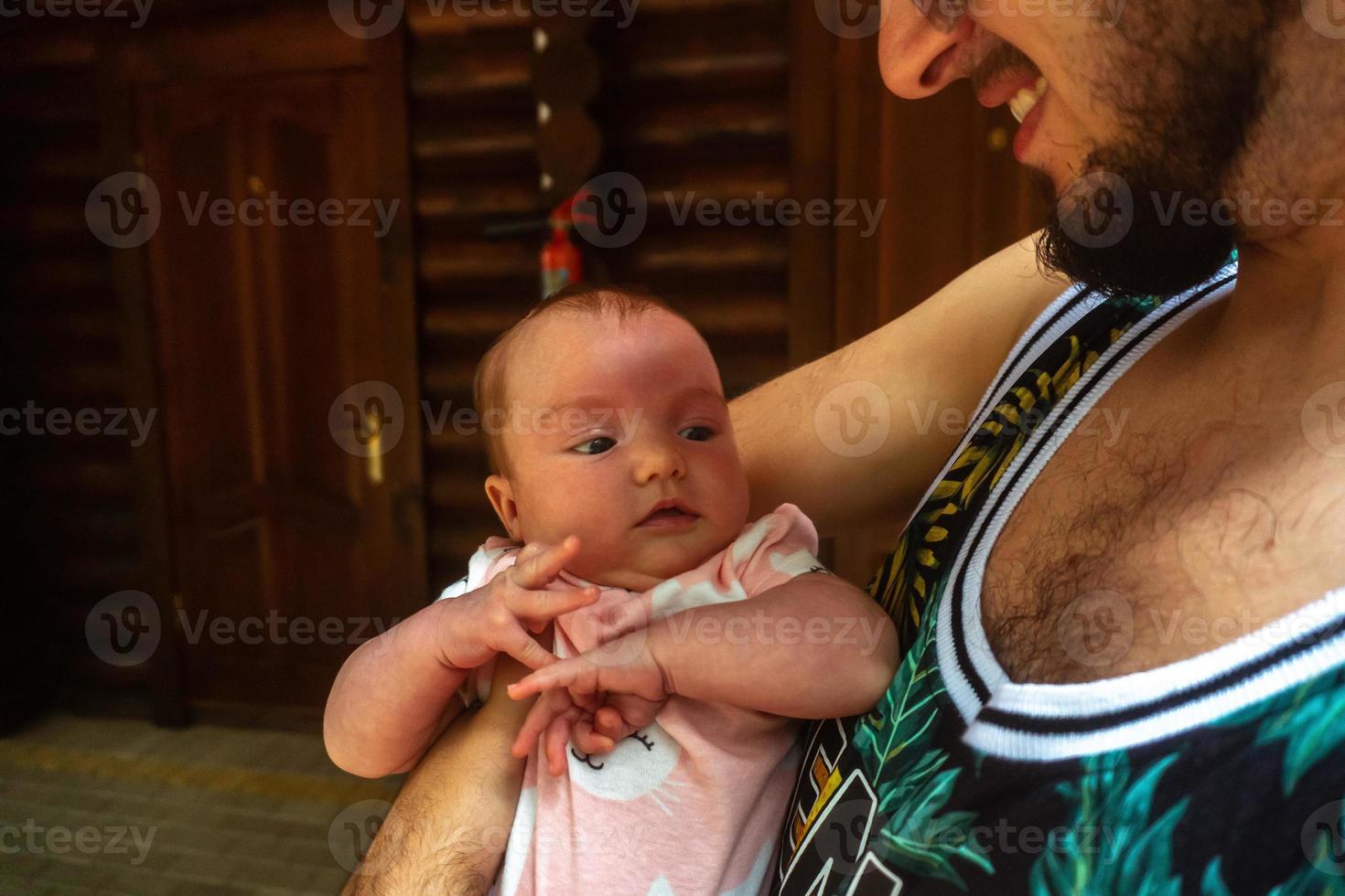 Cute little baby in Daddy's arms photo