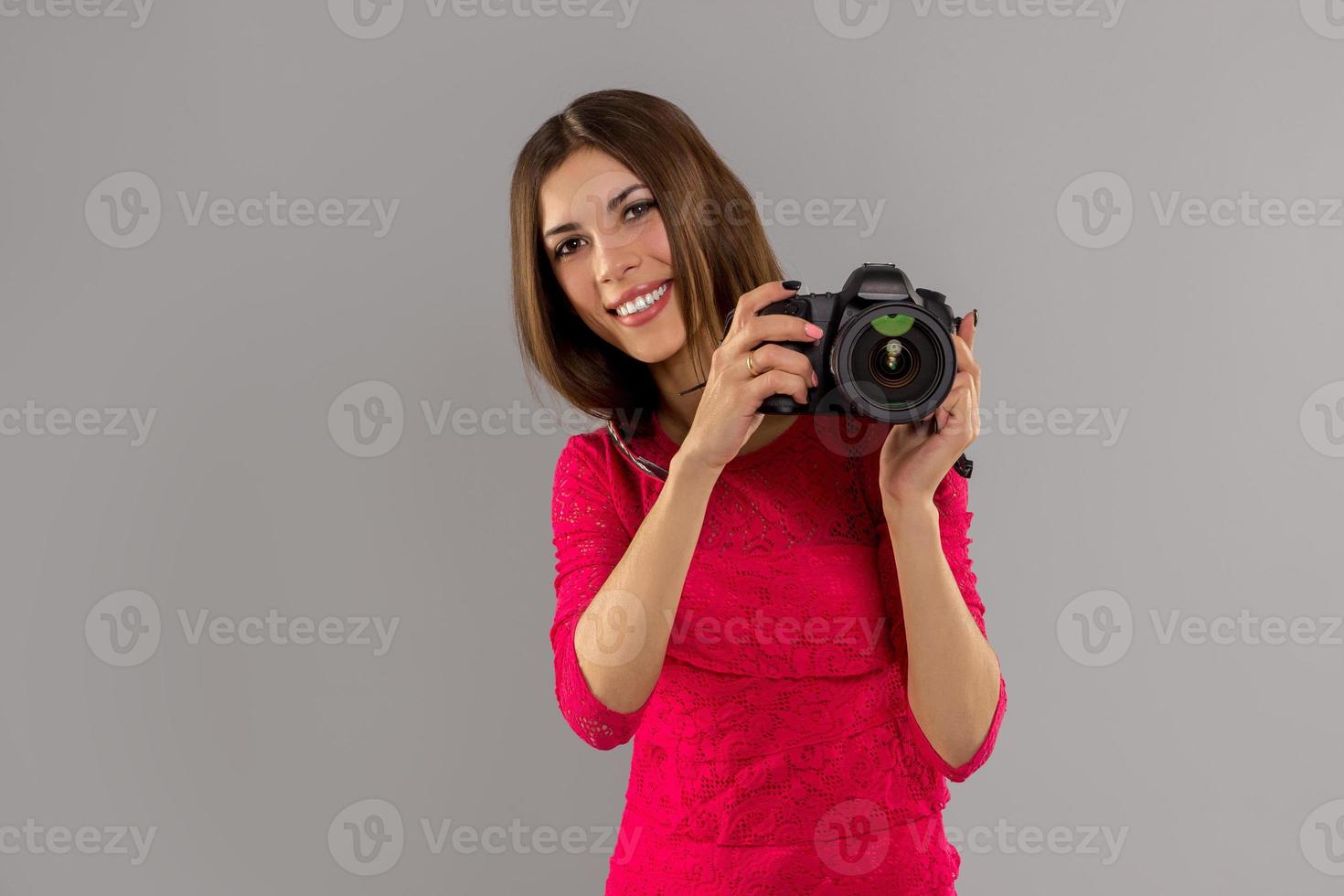 woman smiling with professional photo camera in hands