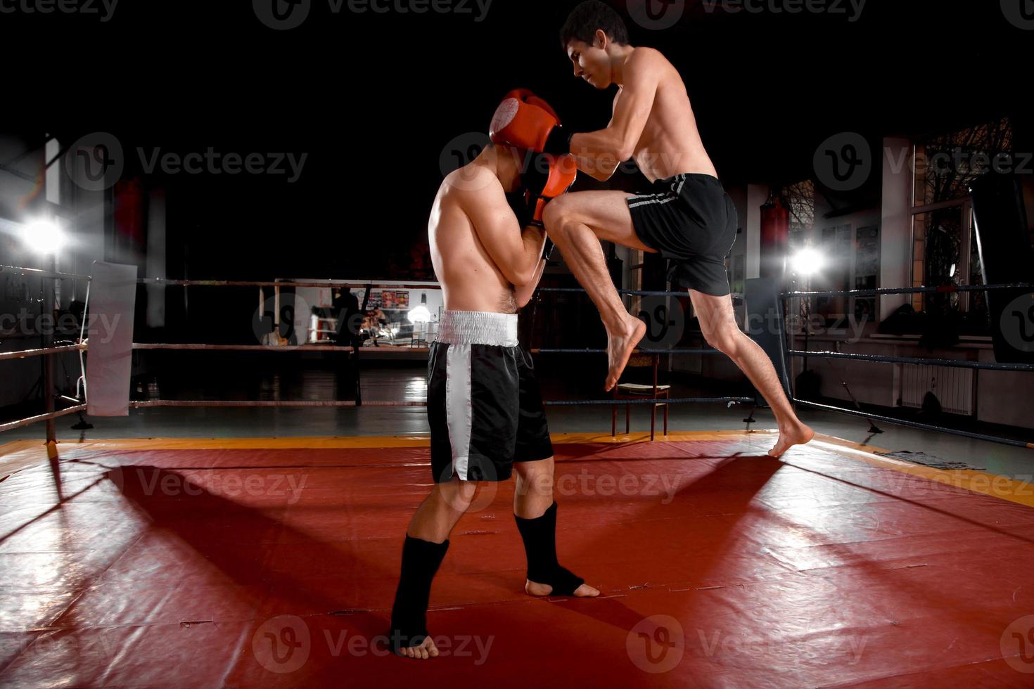 Two men is boxing on the ring photo