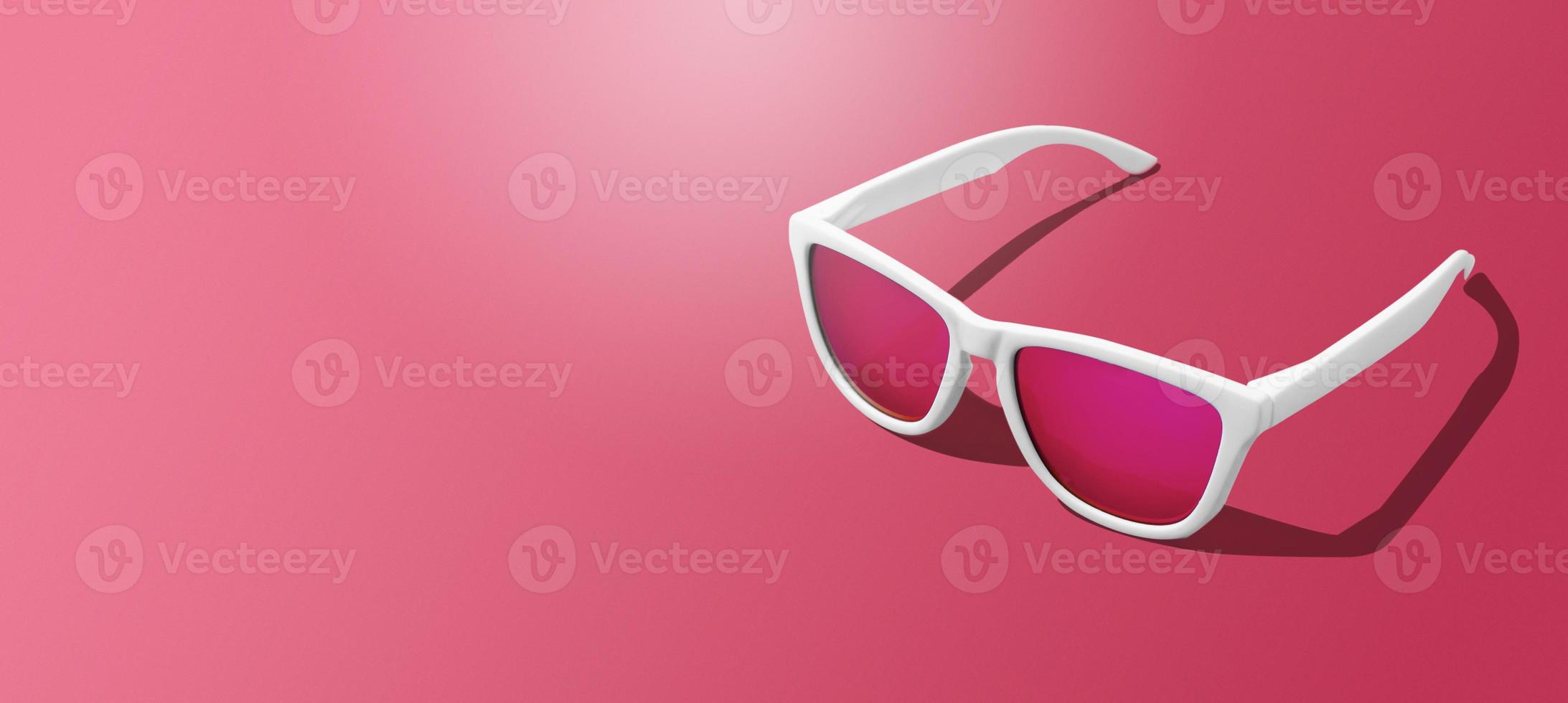 Banner of white sunglasses on magenta background with hard light scene and copy space. Studio shot of modern sunglasses on Viva Magenta tones background. photo