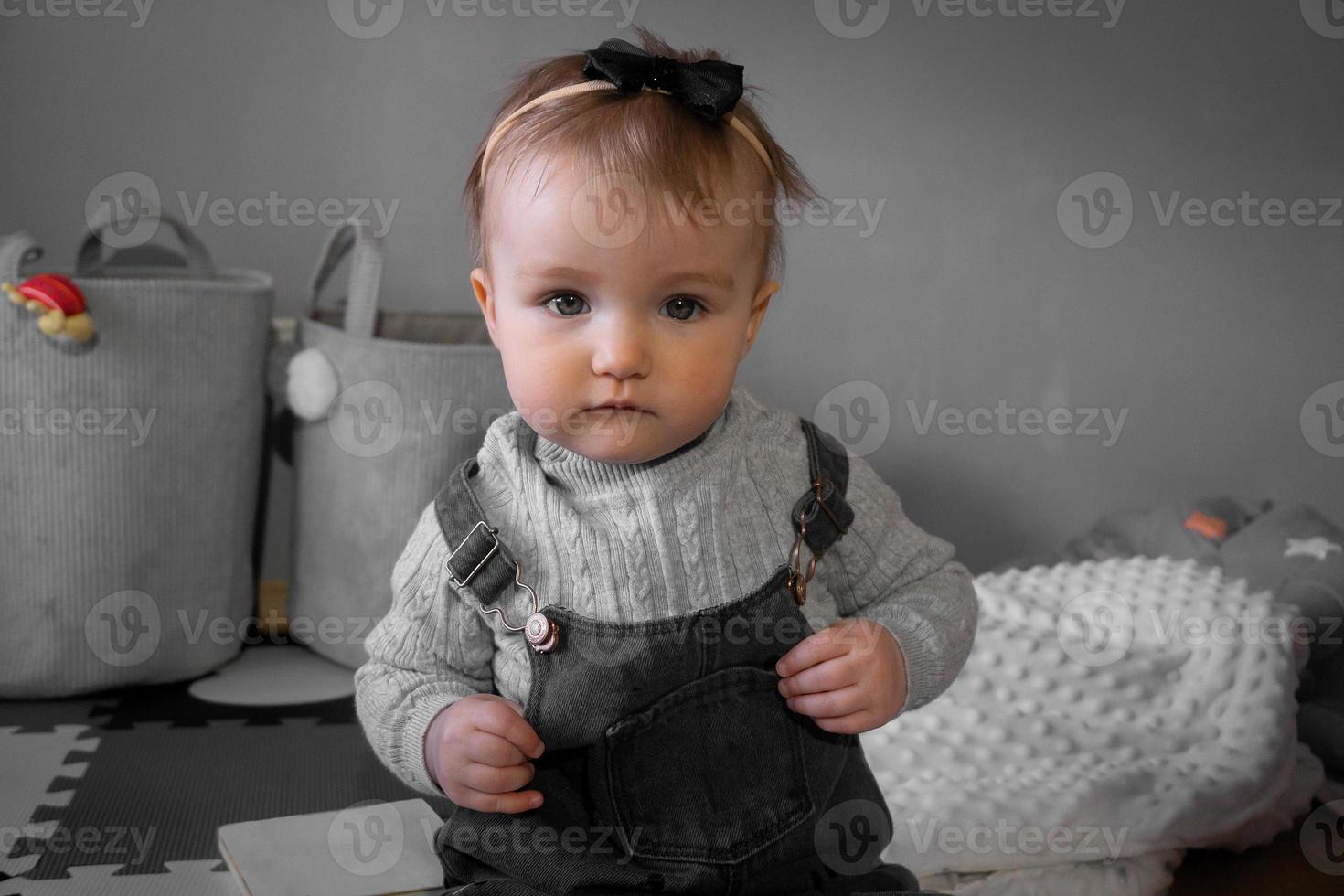 little baby girl looking at the camera at home photo