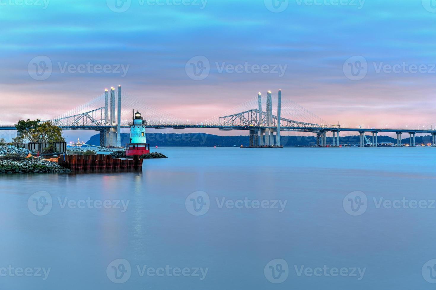 New and Old Tappan Zee Bridges coexisting across Hudson River with a dramatic sunset. photo