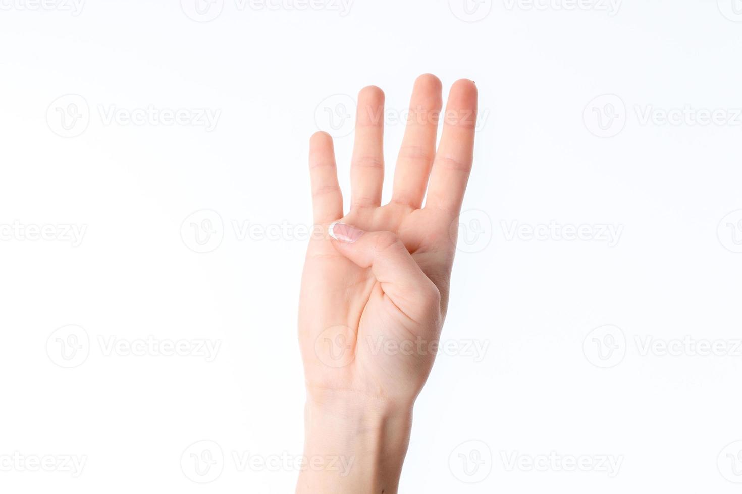 female hand stretched up and showing four fingers isolated on white background photo