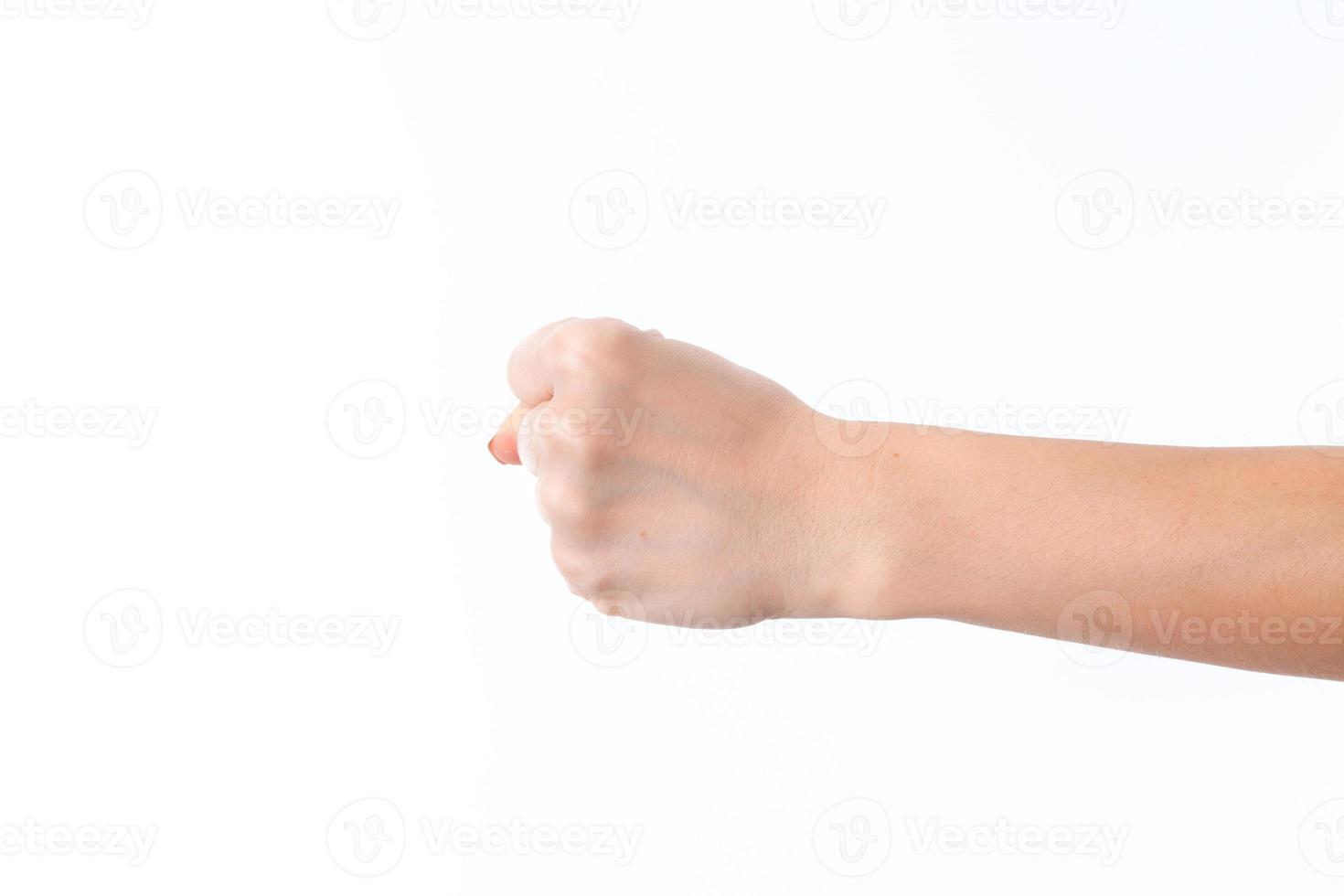 female hand outstretched to the side and showing a fist is isolated on  white background photo