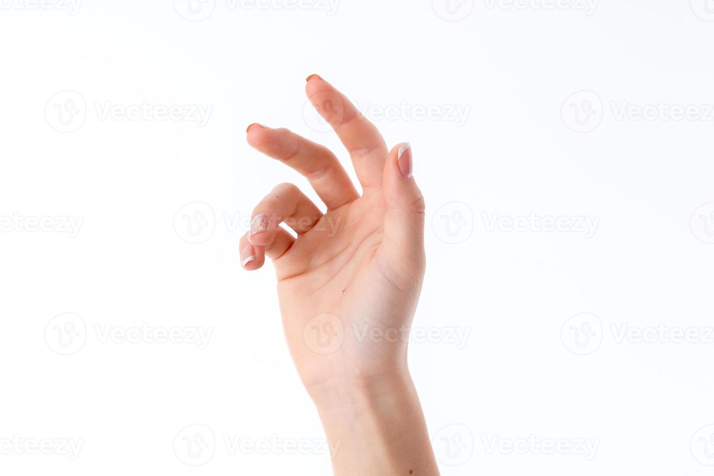 female hand stretched up and showing the gesture with a slightly bent fingers isolated on white background photo