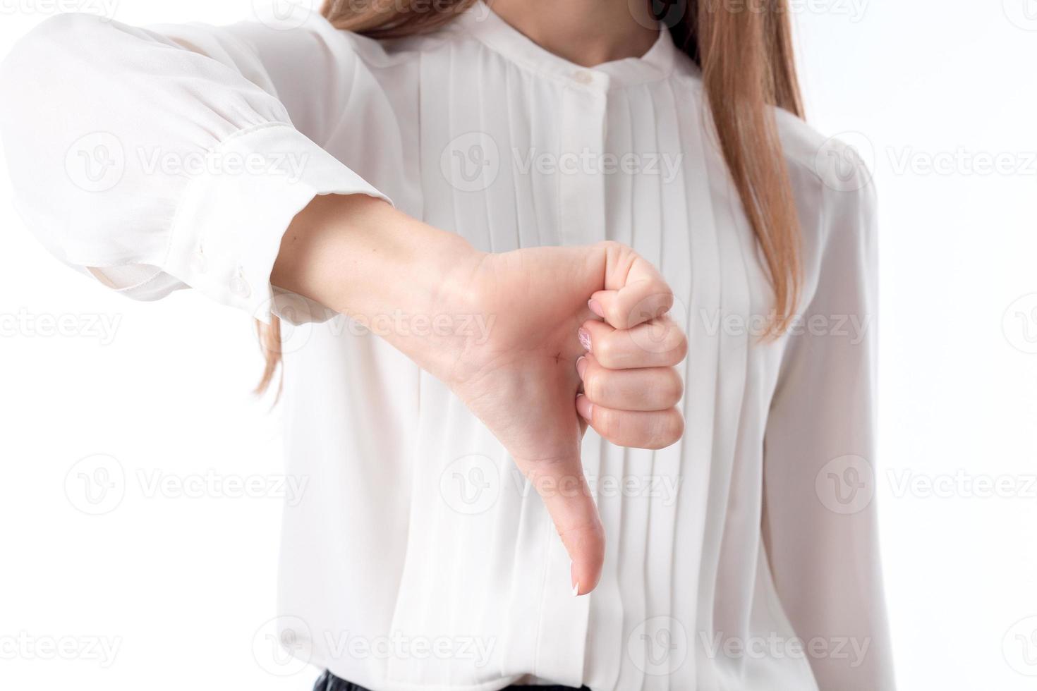 young girl in white shirt shows a hand gesture bad close-up photo