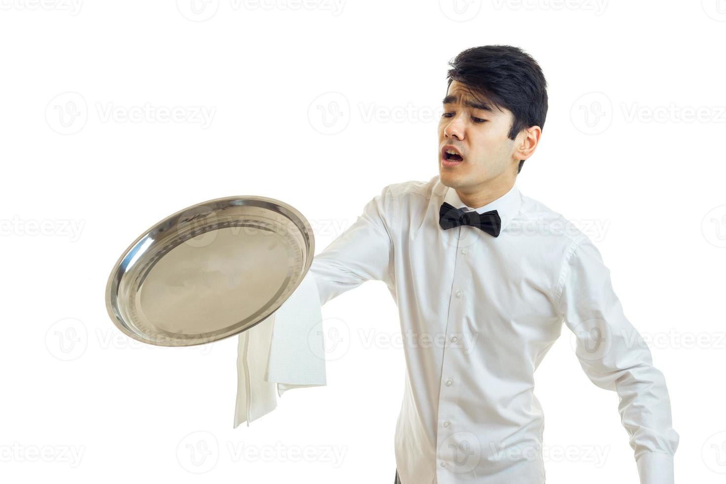 a young bumbling waiter drops on the floor of the empty tray is photo