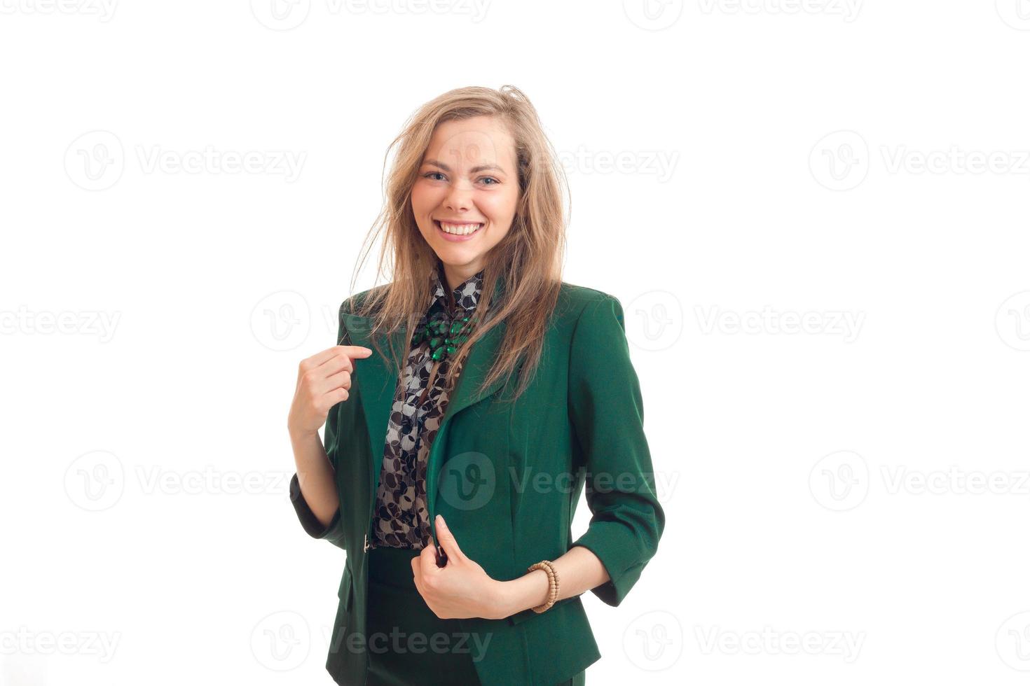 young cute girl in a green jacket looks into the camera and smiling photo