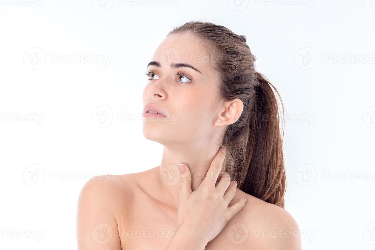 young nude girl looks away and keeps the ball neck is isolated on a white background photo