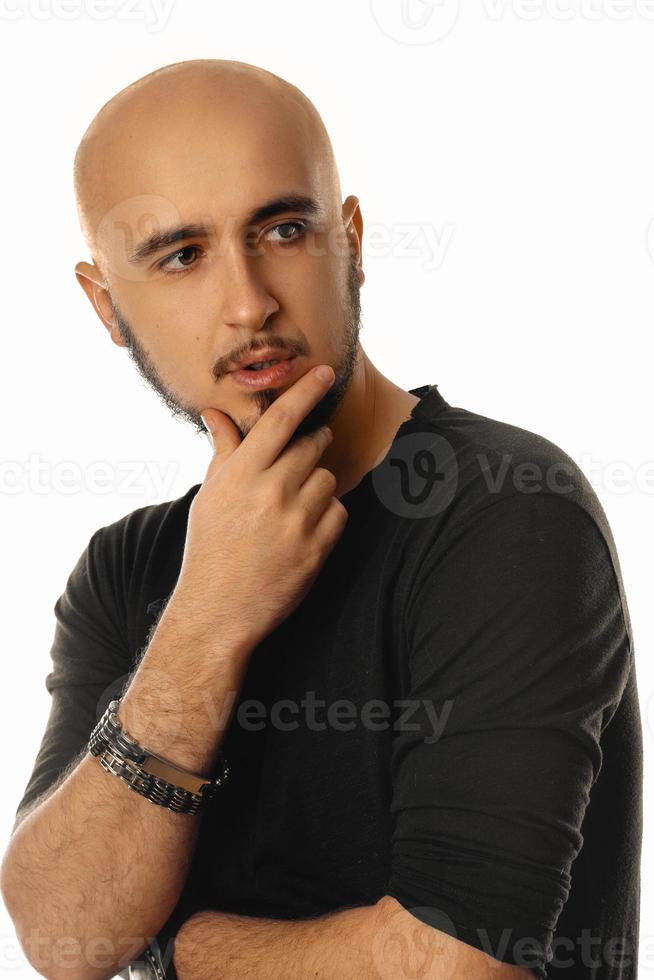 Handsome unshaved macho man posing in studio and looking aside photo