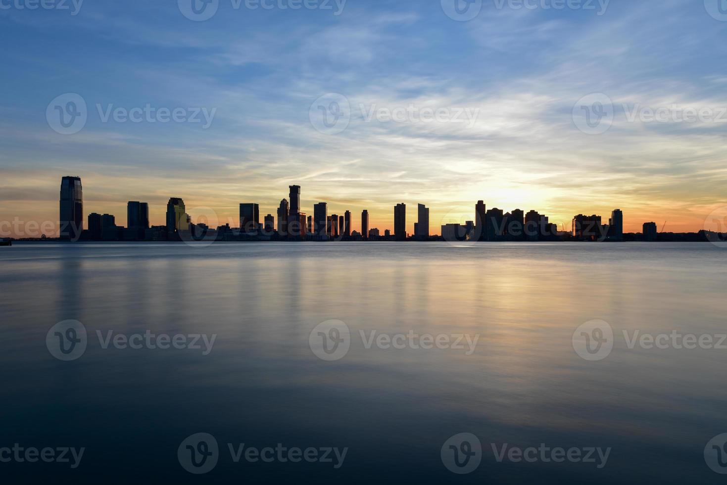 New Jersey skyline at sunset from Manhattan, New York City over the Hudson River. photo