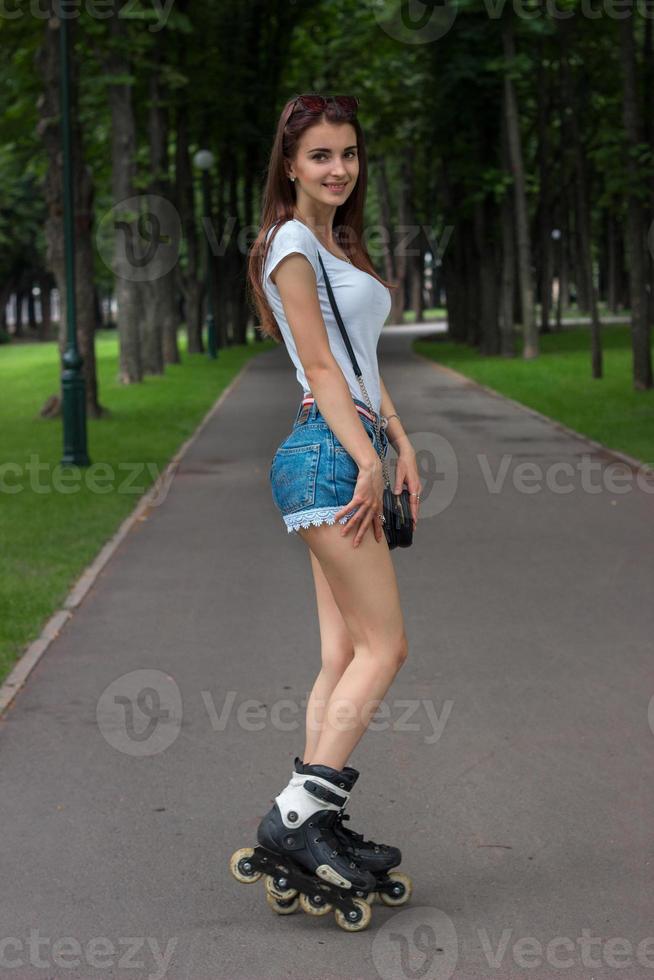 beautiful smiling girl in denim shorts rollerblading 16099949 Stock