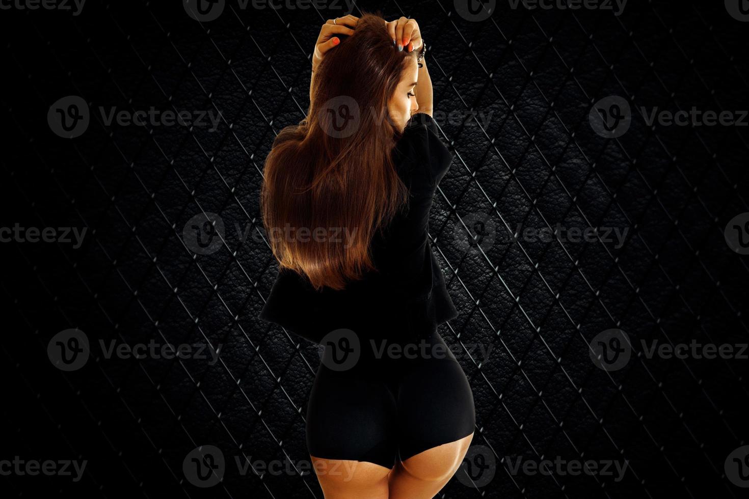 Sexy young brunette girl with beautiful round buttocks in studio photo