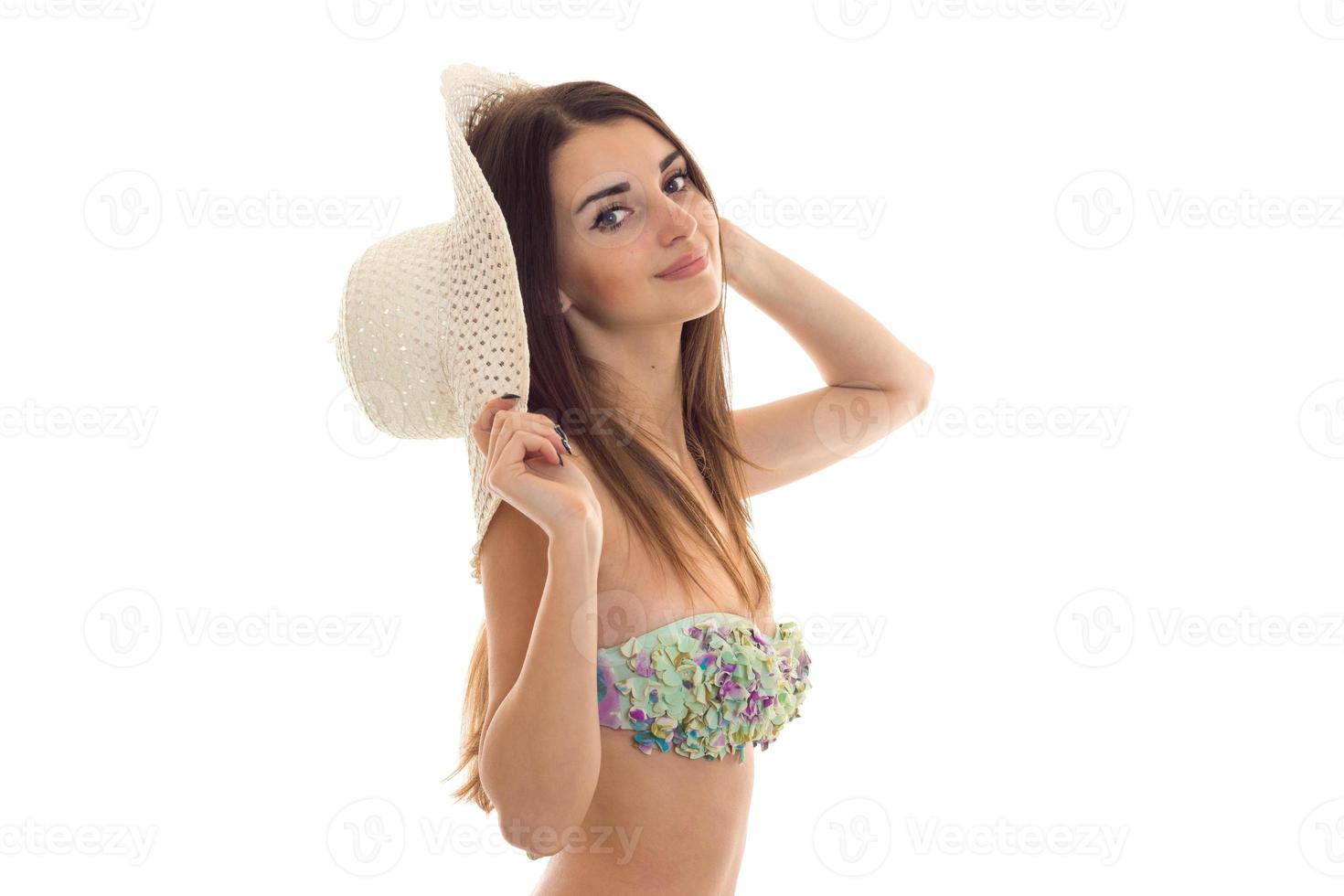 cutie young woman with big natural boobs in swimsuit with floral pattern smiling and looking at the camera isolated on white background photo