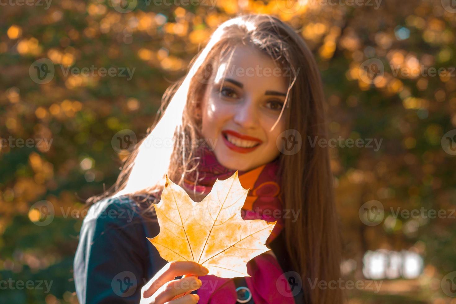 Portrait of a young beautiful girl kotooraja keeps  large sheet and smiling photo