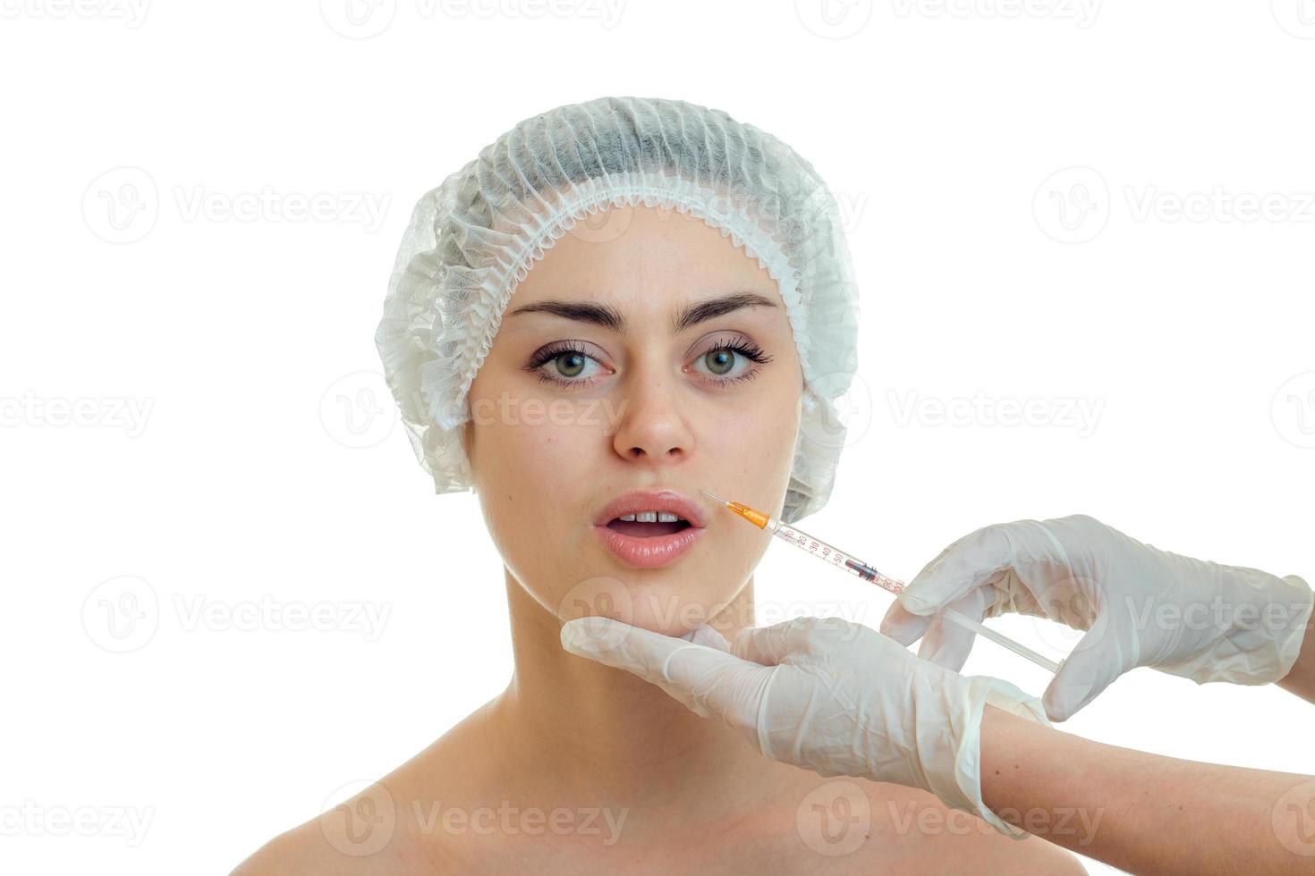 a young girl in the Office of a doctor in the medical hair Hat opened her mouth photo