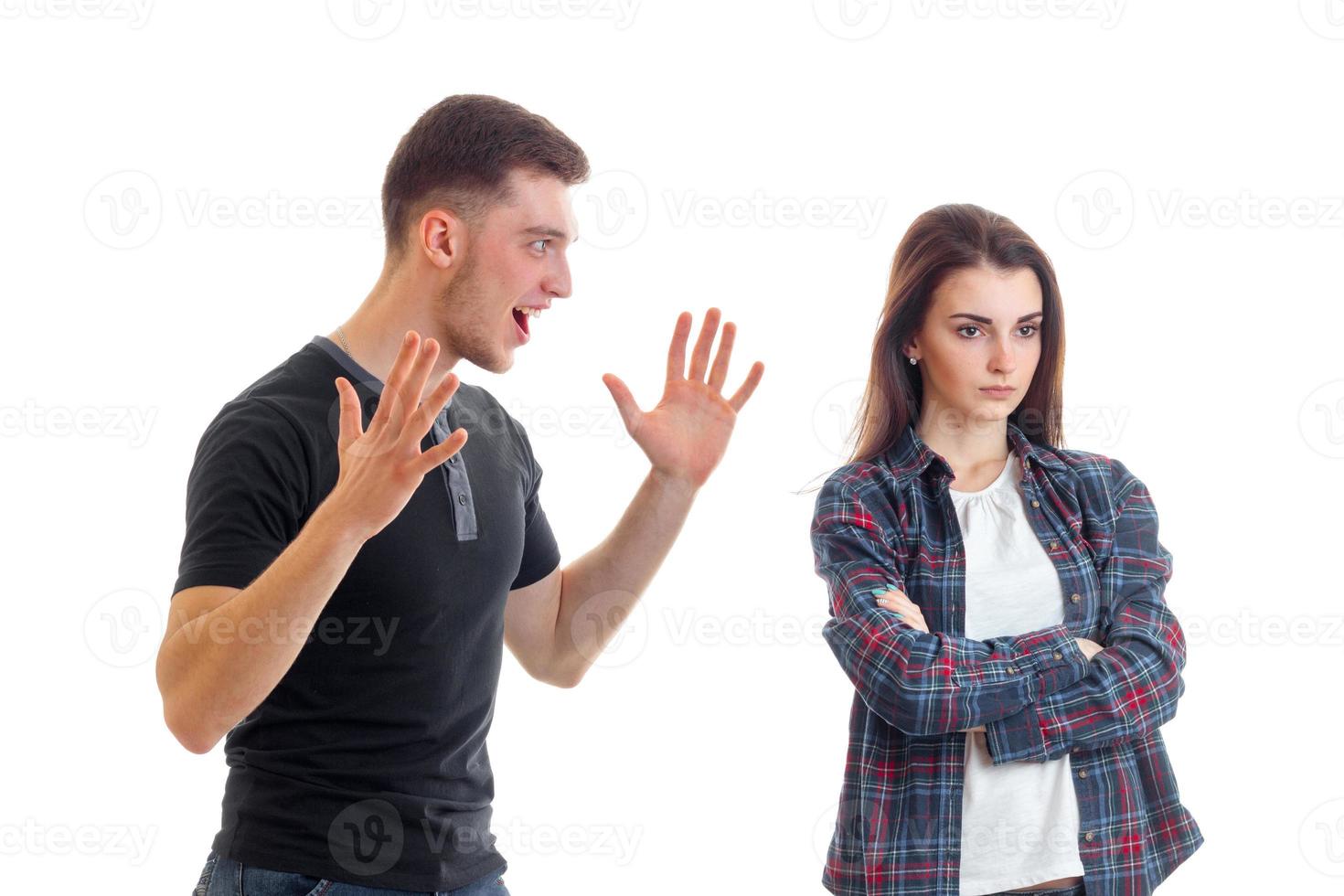 young couple in quarrel faces in the Studio, turning away from each other and the guy screams photo