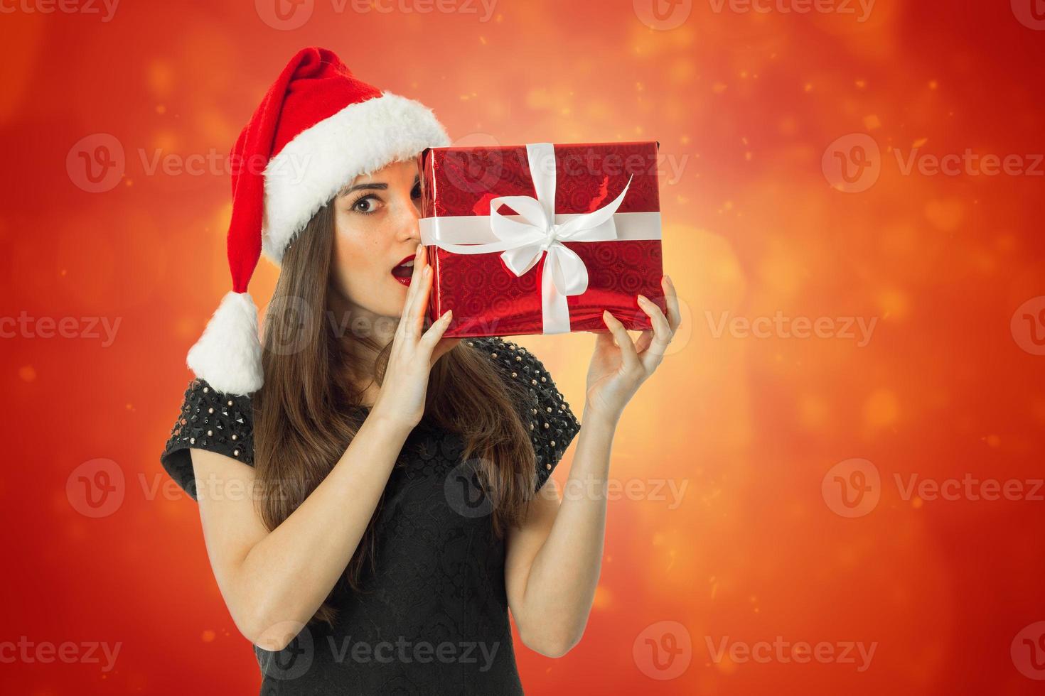beautiful Girl in santa hat with open mouth photo