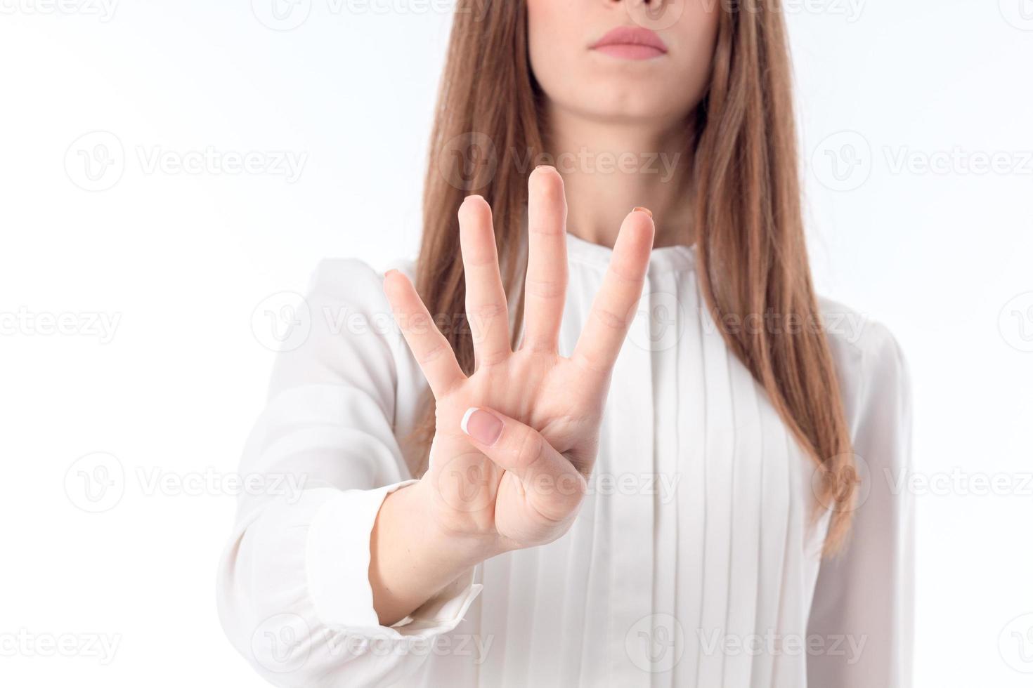 young girl is stretched out in front of  hand and four fingers shows close-up photo