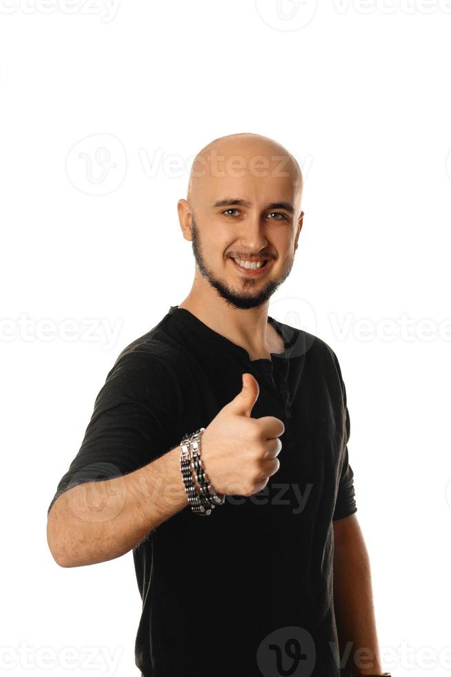 Cheerful man smiling and showing thumbs up gesture on camera photo