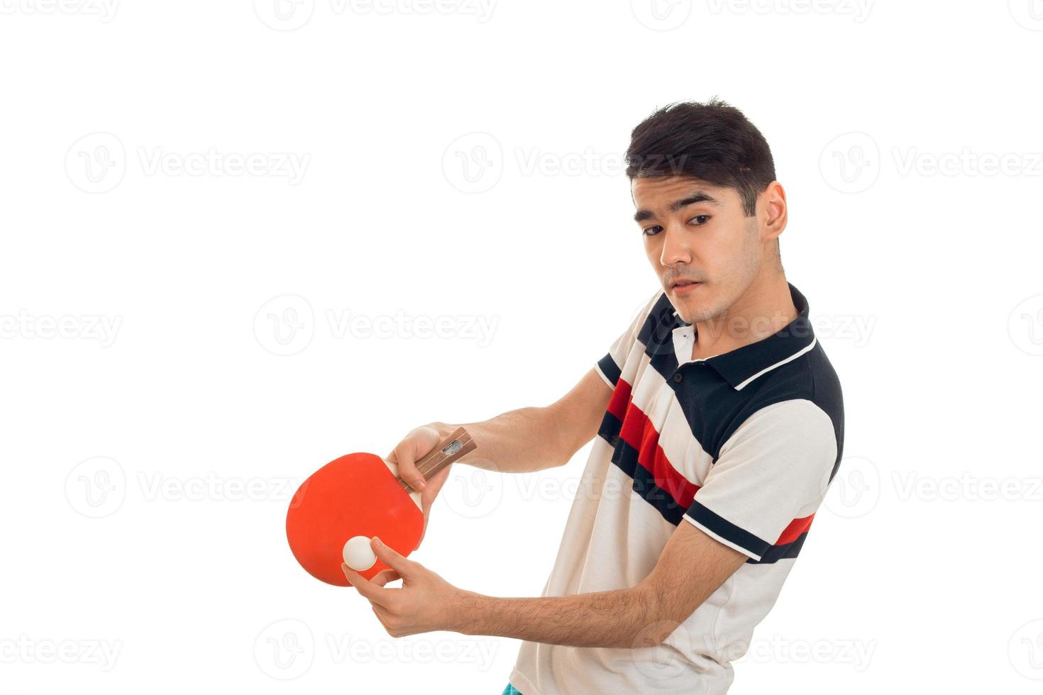 young concentrated sportsman practicing ping-pong isolated on white background photo