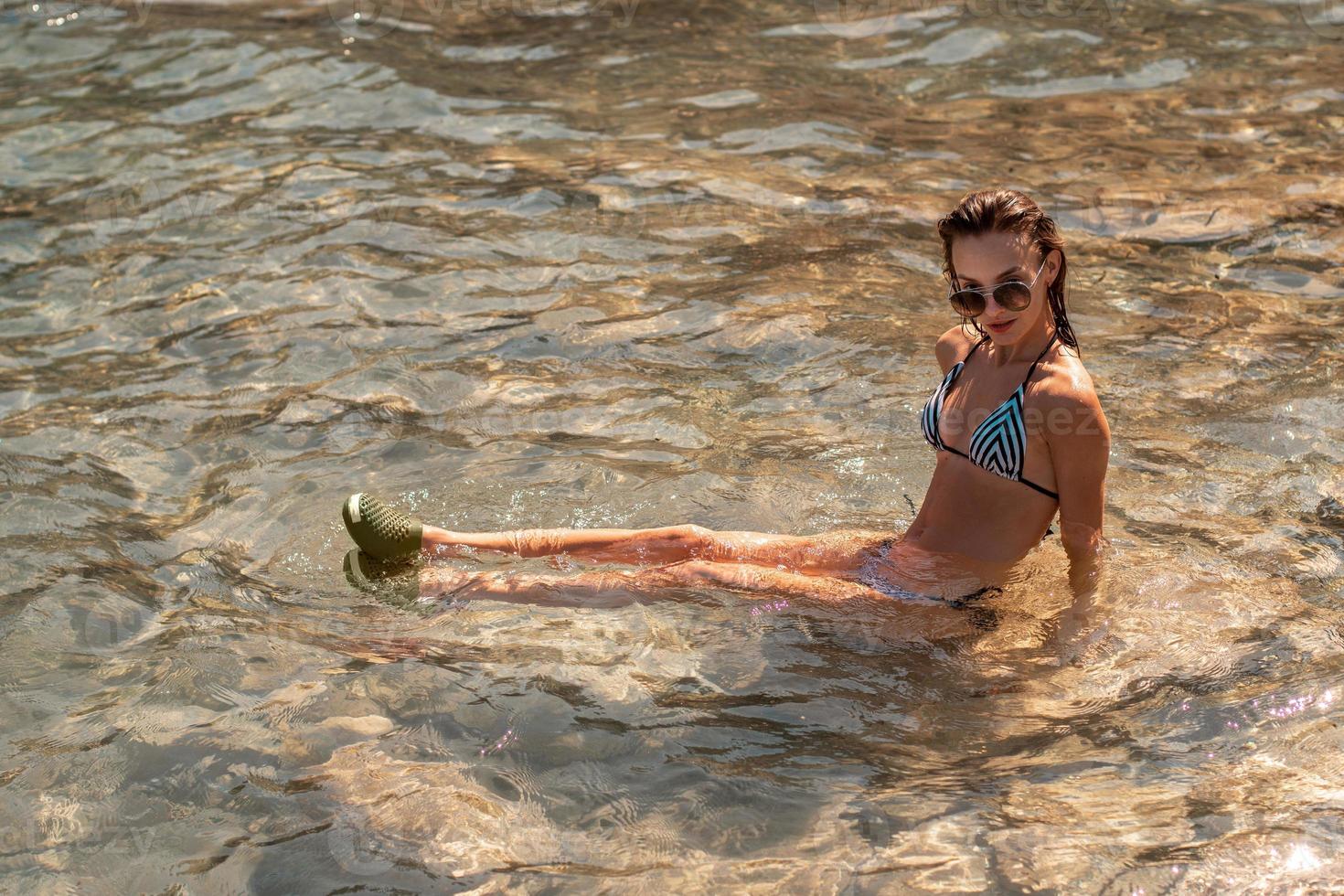 cute girl swims in the clear sea photo