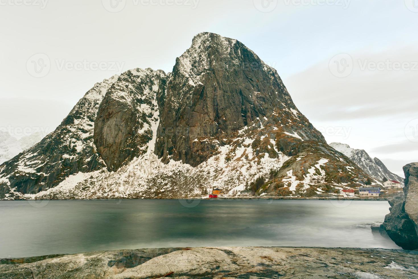 Fishing hut in the Hamnoy and Lilandstinden mountain peak in winter in Reine, Lofoten Islands, Norway. photo
