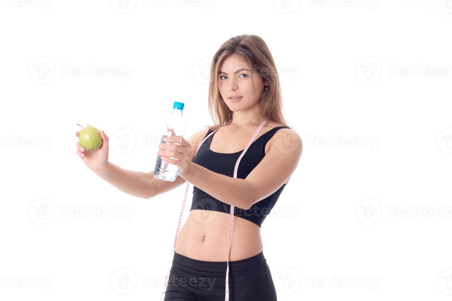 Pretty athletic girl looks forward turned sideways and showing two hands photo