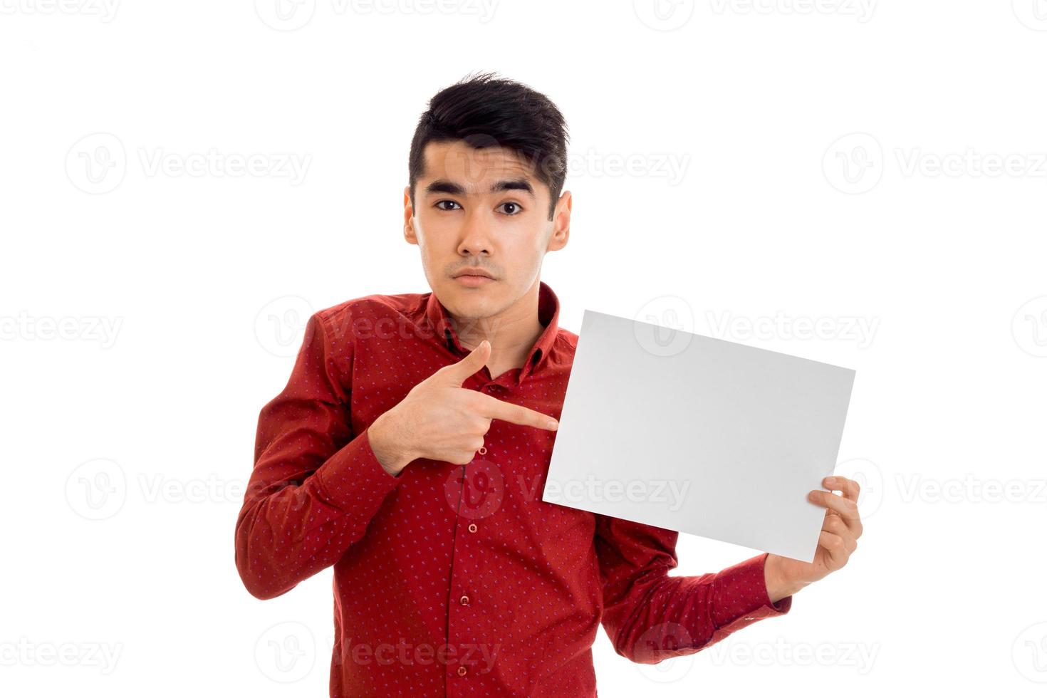 funny young brunette man posing with empty placard in his hands and looking at the camera isolated on white background photo
