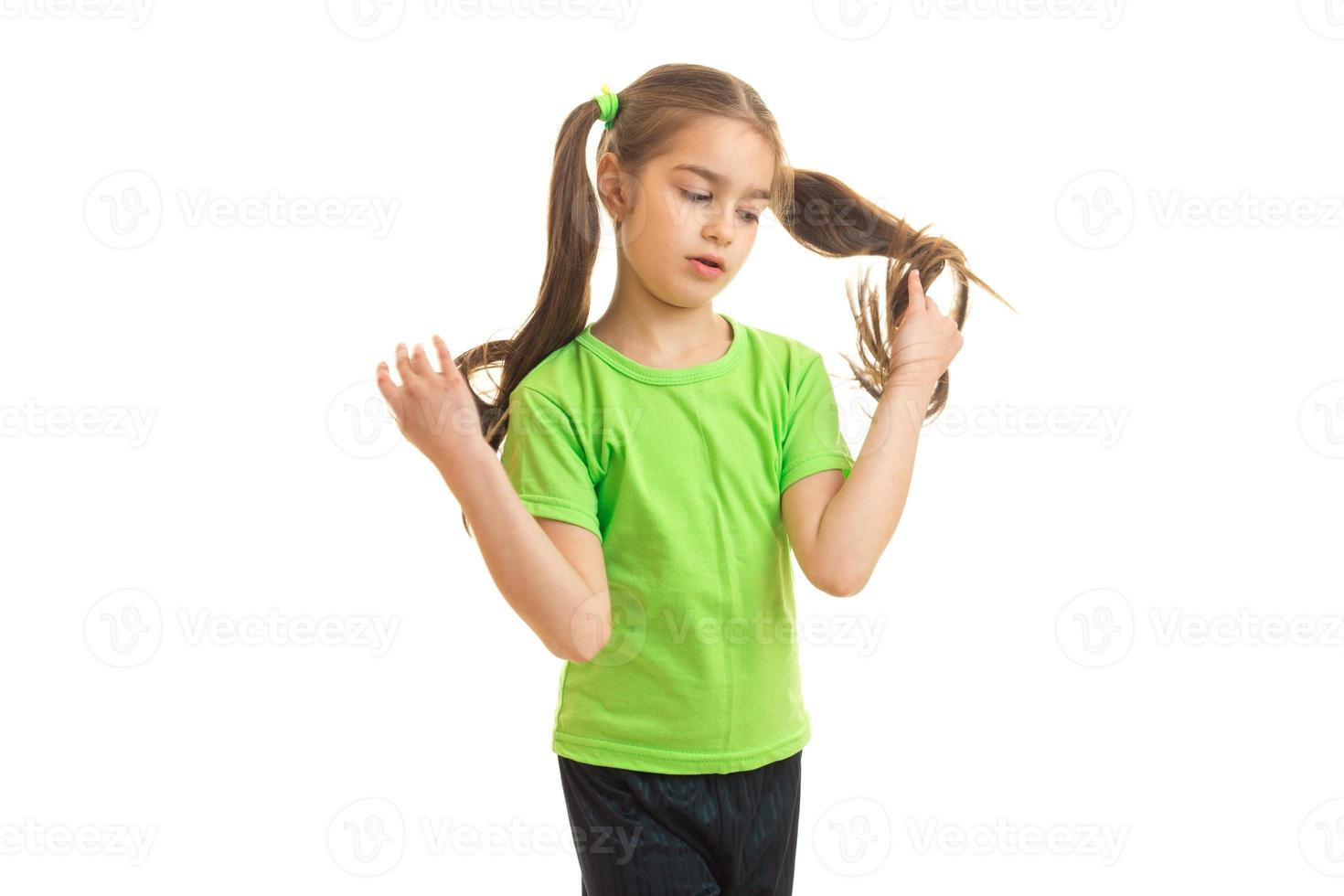 Cutie girl in green shirt posing on camera photo