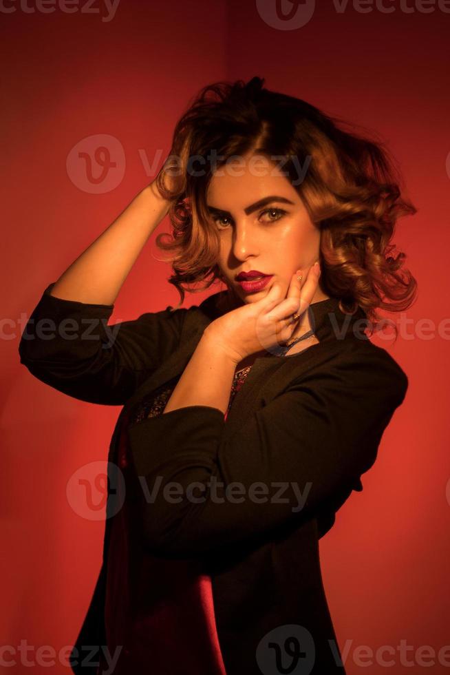 Hot young woman with red lips and curly short hairstyle photo
