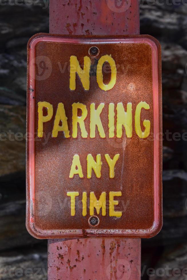 Old rusted No Parking Any Time street sign. photo