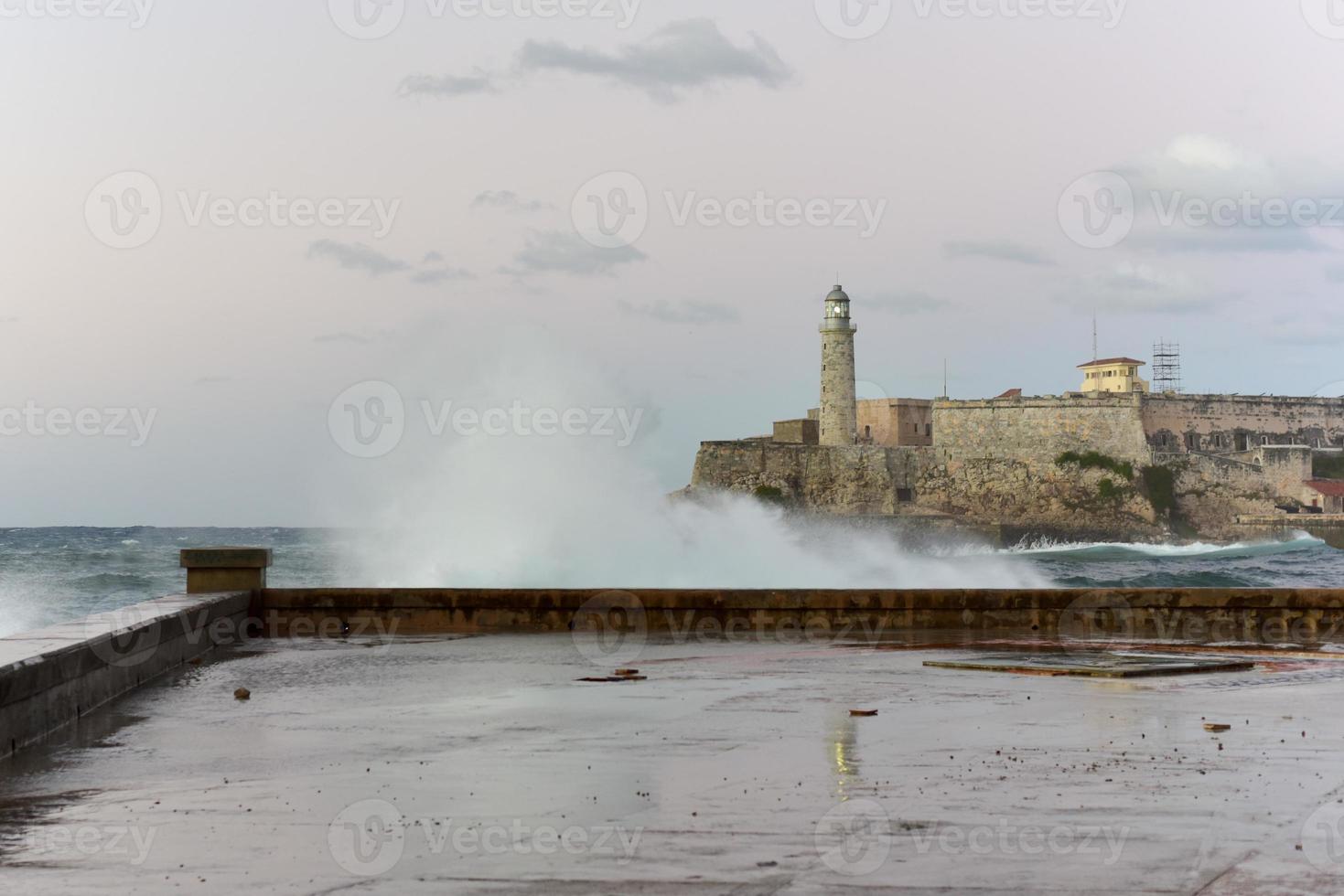 Waves crashing in front of Castillo de los Tres Reyes del Morro in Havana, Cuba. photo