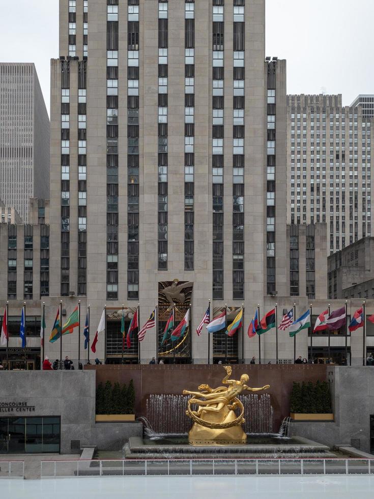New York City - February 27, 2019 -  Prometheus Statue at Rockefeller Center in New York City in the winter with the ice skating rink. photo