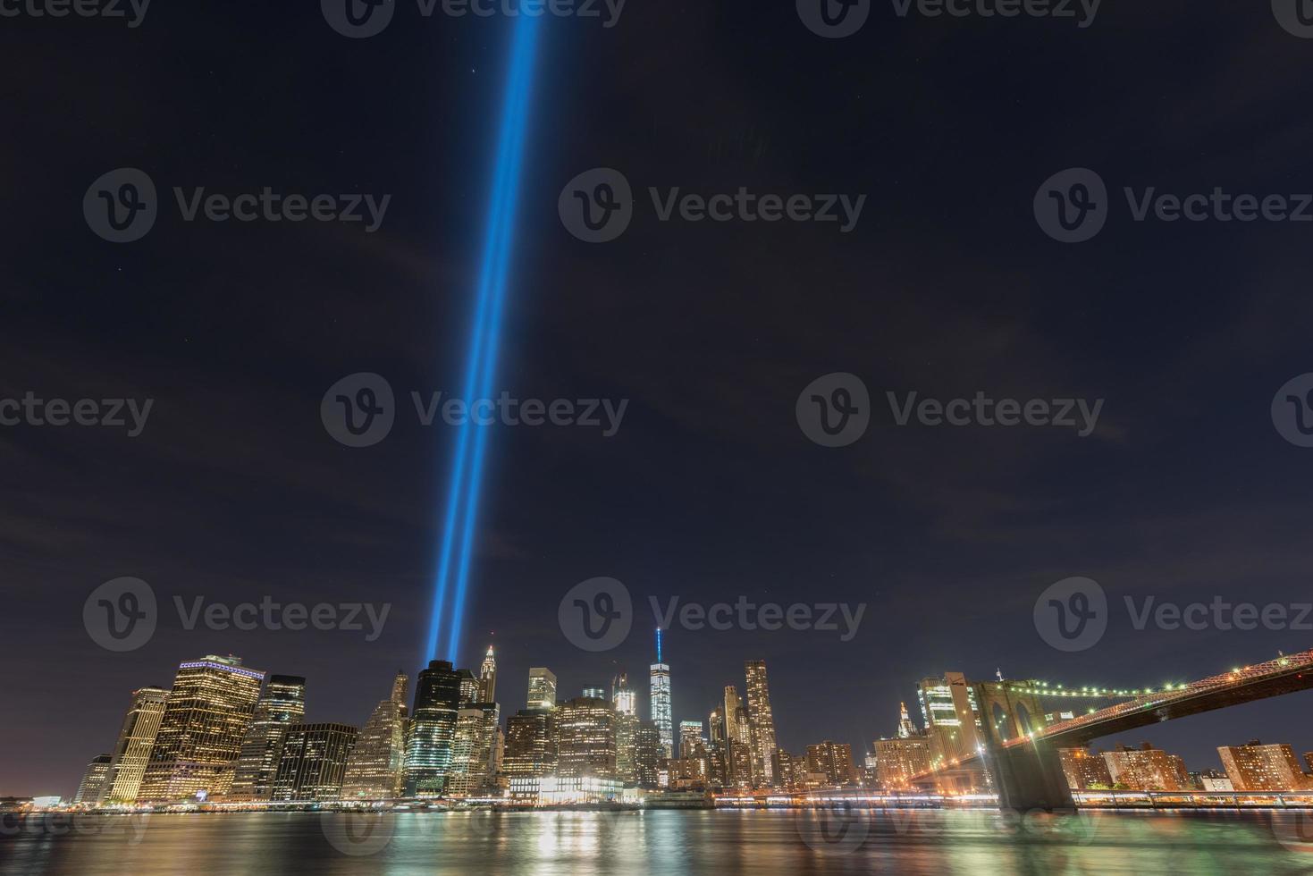 New York City Manhattan downtown skyline at night with the Tribute in Light in memory of September 11. photo