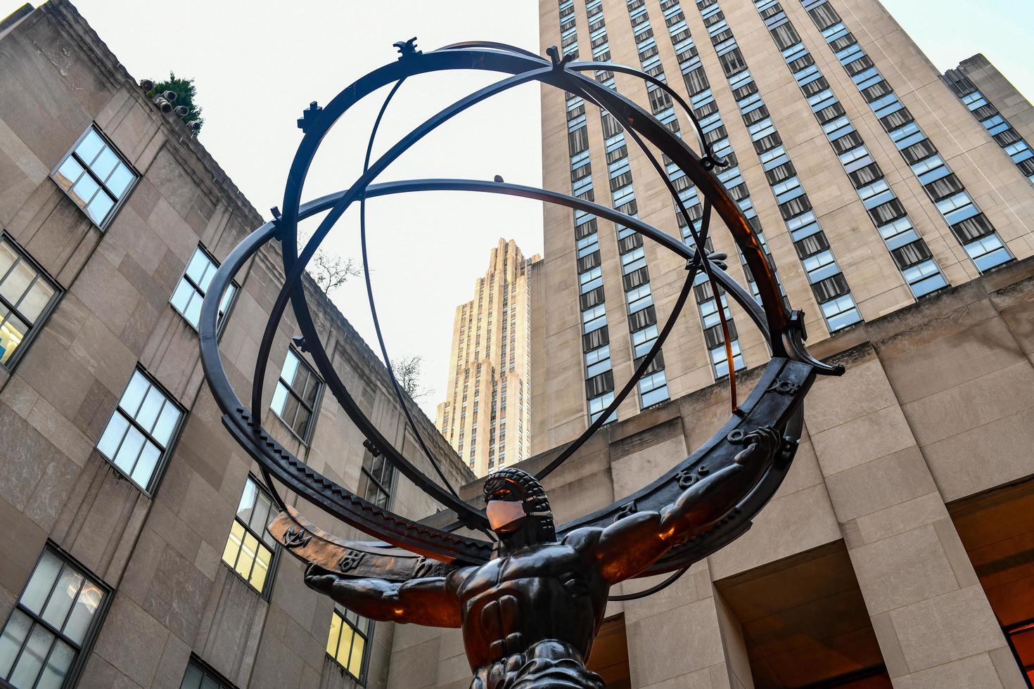 New York, NY - Nov 14, 2020 -  Real estate firm Tishman Speyer fitted masks on Atlas and other classic statues in Rockefeller Center to encourage New Yorkers to wear COVID-19 face coverings. photo
