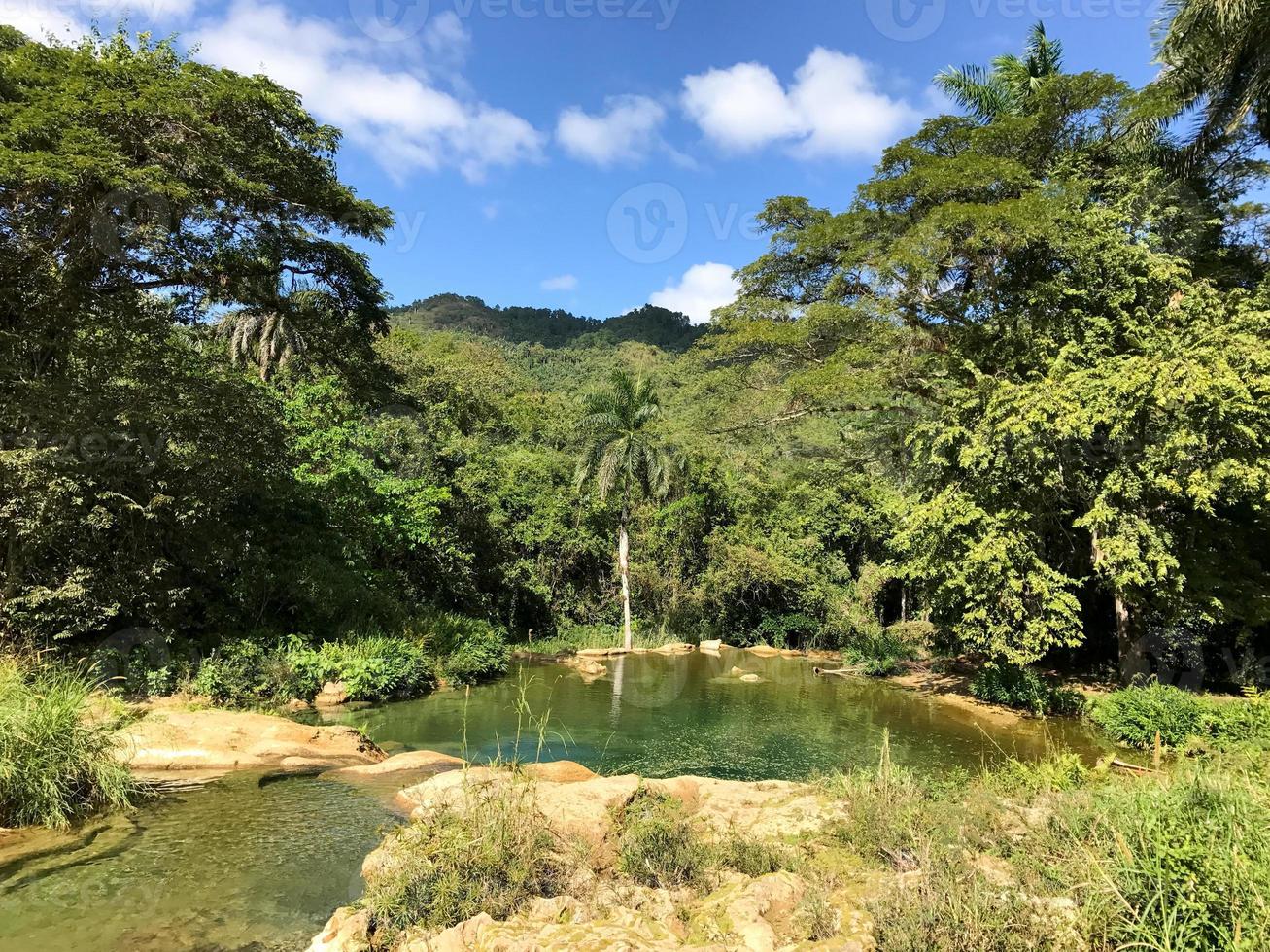 El Nicho Waterfalls in Cuba. El Nicho is located inside the Gran Parque Natural Topes de Collantes, a forested park that extends across the Sierra Escambray mountain range in central Cuba. photo