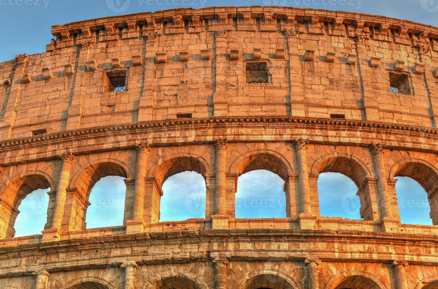 Ancient Roman Colosseum at sunset in Rome, Italy. photo