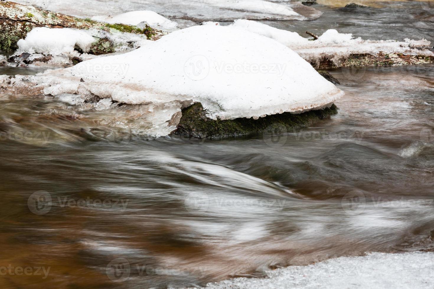 A Small Rocky Forest River in Winter photo