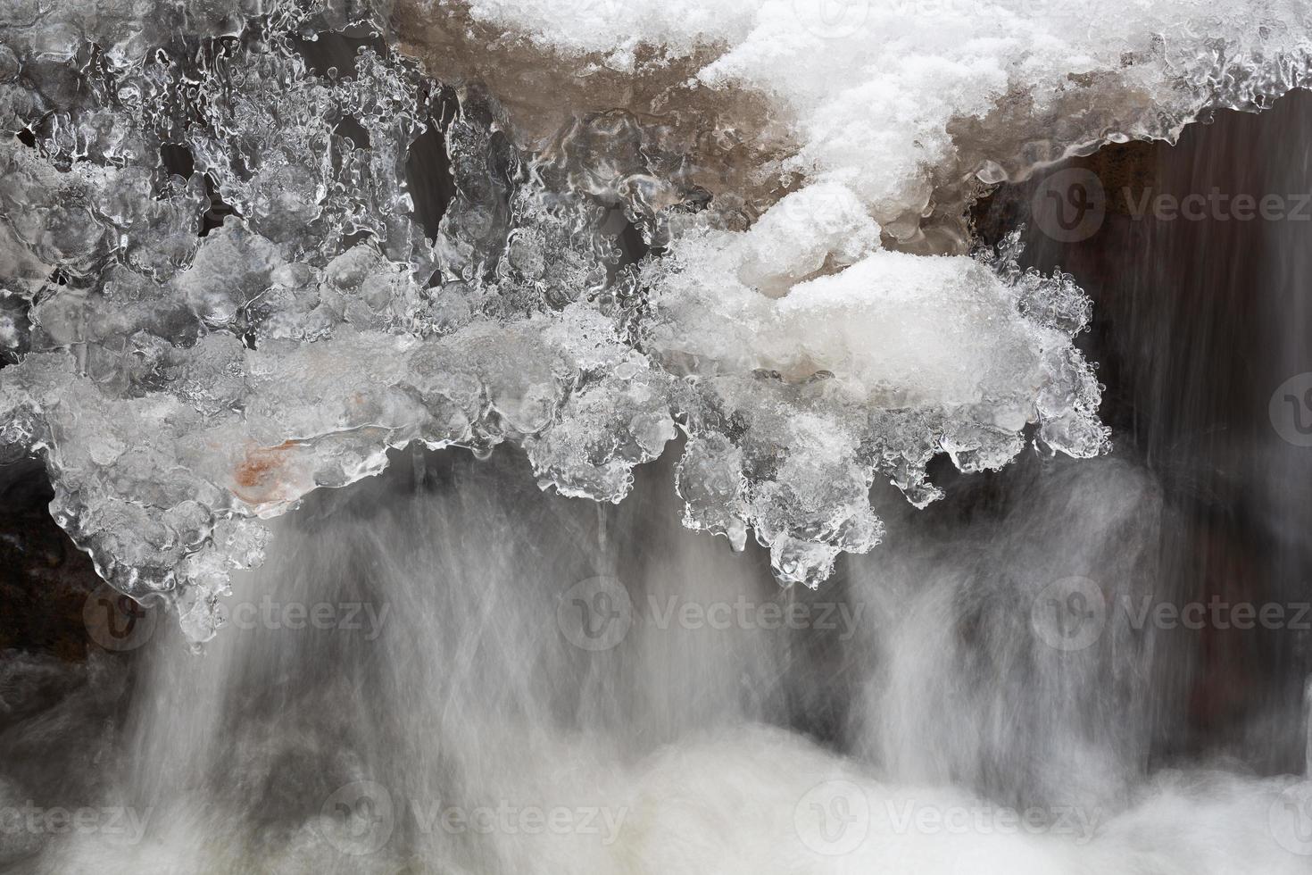 A Small Rocky Forest River in Winter photo