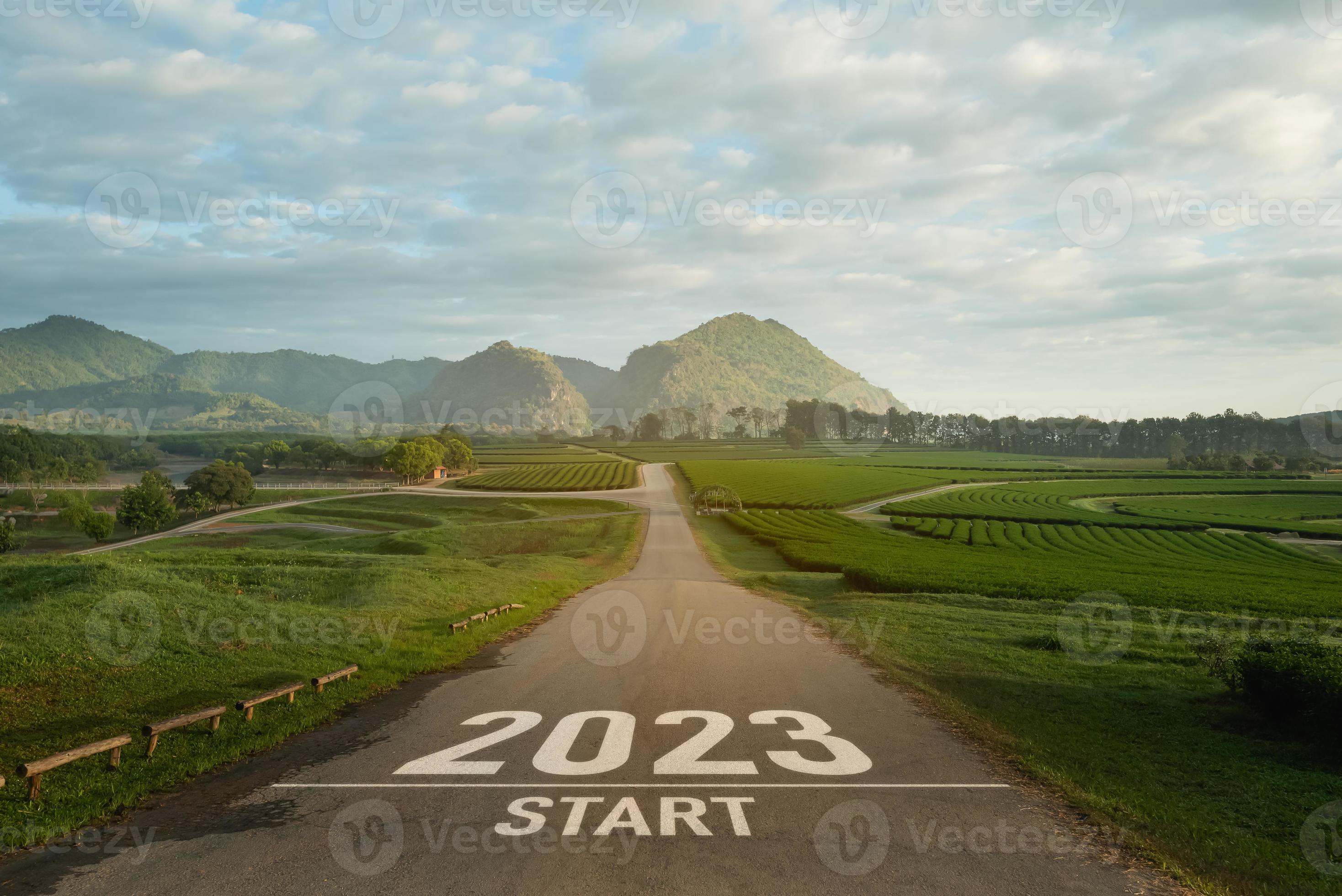 Happy new year 2023,2023 symbolizes the start of the new year. The letter  start new year 2023 on the road in the nature fresh green tea farm mountain  environment ecology or greenery